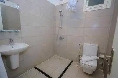 a bathroom with a toilet and a sink at Cleopatra Hotel in Aswan