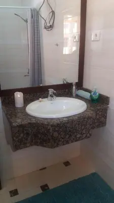 a bathroom counter with a sink and a mirror at Apartment in Stella di Mare Hurghada in Hurghada