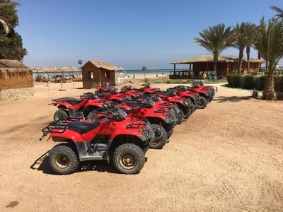 a row of red atvs parked on the beach at Apartment in Stella di Mare Hurghada in Hurghada
