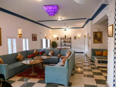a living room with couches and tables in a room at El Gezira Hotel in Luxor