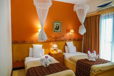 a hotel room with two beds with stuffed animals on them at El Gezira Garden Hotel Luxor in Luxor