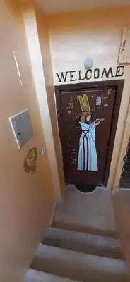 a set of stairs with a welcome sign on a door at Apartment in Luxor city center-Nil in Luxor