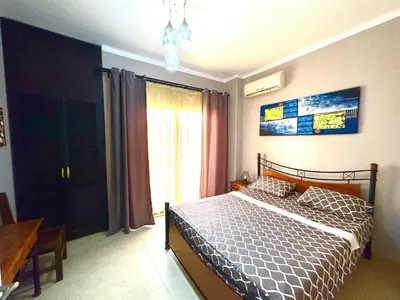 a bedroom with a bed and a table and a window at Elephant House with Sea View in Hurghada