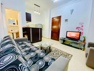 a living room with a couch and a tv at Elephant House with Sea View in Hurghada