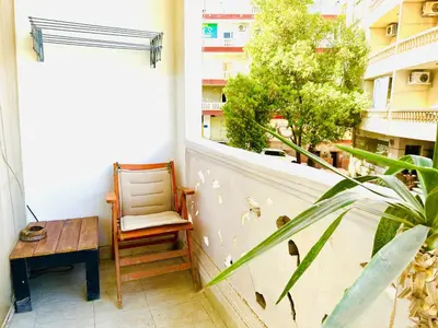 a balcony with a chair and a table and a window at Jazz House Hurghada canter with WI FI in Hurghada