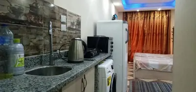 a kitchen with a sink and a refrigerator at Chalet in Cecelia Resort in Hurghada