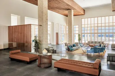a living room with a couch and chairs and tables at JAZ Elite Maraya in Coraya Bay