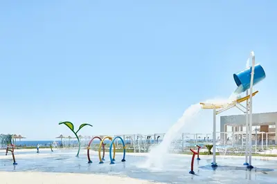 a water park with a fountain and water slides at JAZ Elite Maraya in Coraya Bay
