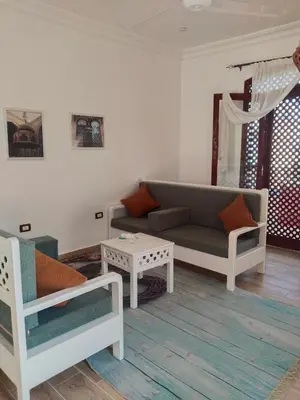 a living room with a couch and a table at Villa Quiet Place in Luxor