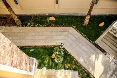 an overhead view of a garden with palm trees at Serenity Home Hurghada in Hurghada