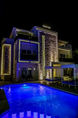 a large blue swimming pool in front of a building at Serenity Home Hurghada in Hurghada