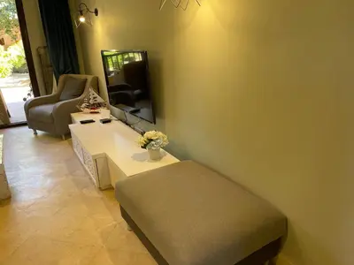 a living room with a couch and a table and a mirror at El gouna South Marina Townhouse Apartment 3 bedrooms in Hurghada