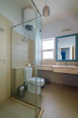 a bathroom with a toilet and a glass shower at Luxury 3 Bedroom Apt. in El Gouna with amazing view in Hurghada