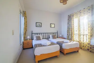 a bedroom with two twin beds and a window at Luxury 3 Bedroom Apt. in El Gouna with amazing view in Hurghada