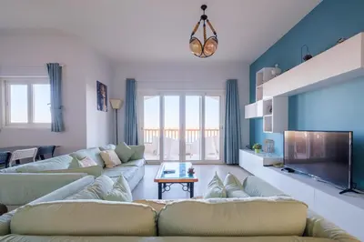 a living room with two couches and a tv at Luxury 3 Bedroom Apt. in El Gouna with amazing view in Hurghada