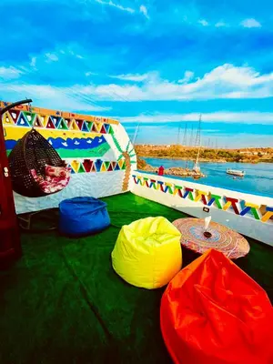 a boat with several colored bean bags on the ground at Kendaka Nubian House in Aswan