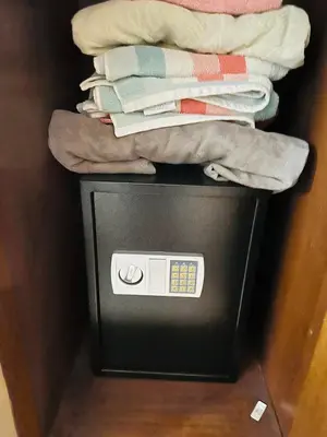 a pile of towels sitting on top of a television at Alis Villa in Hurghada
