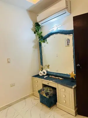 a room with a vanity with a large mirror at Alis Villa in Hurghada