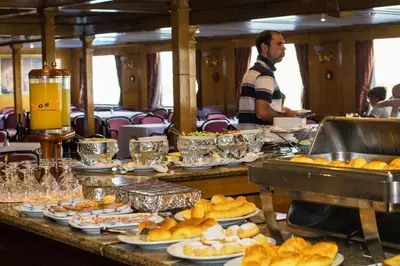 a buffet line with plates of food on a train at GTS Nile Cruise Luxor Aswan every monday from Luxor friday from Aswan in Luxor