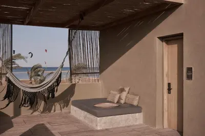 a room with a hammock and a view of the beach at Casa Cook El Gouna - Adults Only in Hurghada