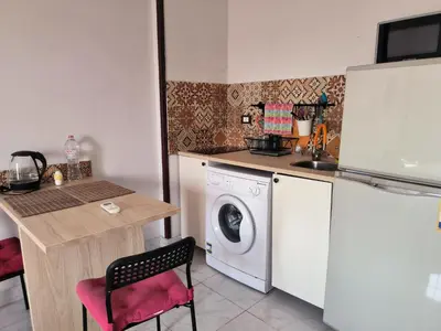 a kitchen with a washing machine next to a counter at Studio 5min from ElGouna and Kite station in Hurghada