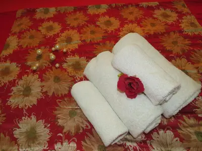 two towels on a table with a flower on it at Apartment Dolce Vita near the sea RedSeaLine in Hurghada