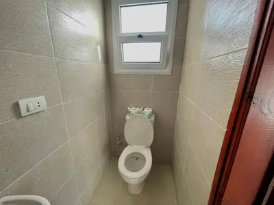 a small bathroom with a toilet with a window at Nile Panorama Hotel & Restaurant in Luxor