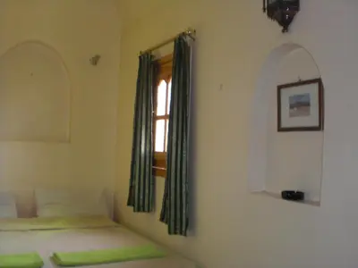 a bedroom with a bed and a window at El Fayrouz Hotel in Luxor