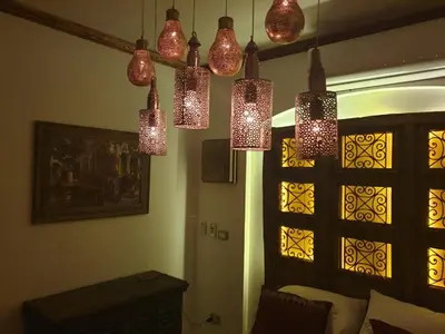 a room with several lights hanging from the ceiling at Dar Om Ali ElGouna Sabina y160 2 14 in El Gouna