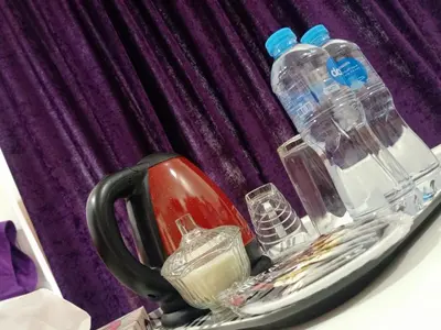 a tray with bottles and glasses on a table at Onaty Ka Guest House in Aswan
