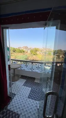 a view of a balcony with a table and a window at Onaty Ka Guest House in Aswan