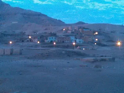 a town in the middle of a field at night at Pharaohs Hotel in Luxor