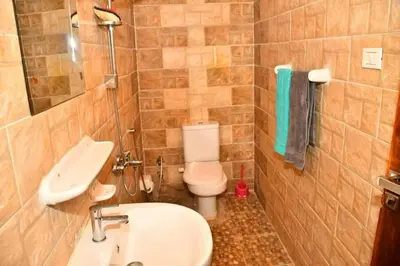 a small bathroom with a toilet and a sink at Om-Abdallah in Aswan