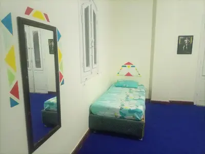 a room with a mirror and a bed in it at Hana hostel not for Egyptian in Hurghada
