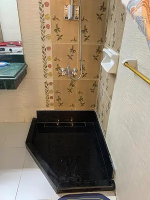 a shower with a black tub in a bathroom at Roma Apartment ( Center Of Hurghada, Sheraton Road ) in Hurghada
