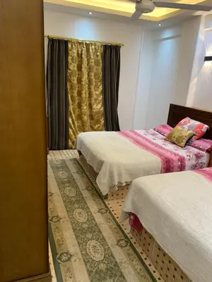 a bedroom with two beds and a window at Roma Apartment ( Center Of Hurghada, Sheraton Road ) in Hurghada