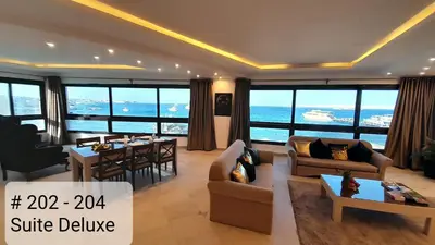 a living room with a view of the ocean at Alia Beach Residence in Hurghada