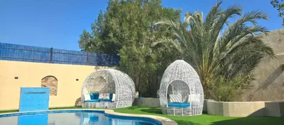 two white wicker arches around a swimming pool at Luxury Royal Blue Family Villa 8pers private pool in Hurghada