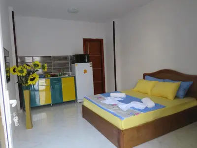 a bedroom with a bed with towels and a refrigerator at Apartment Bella Donna near the sea RedSeaLine. in Hurghada