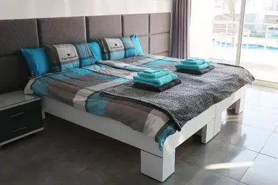 a bed with blue pillows on it in a bedroom at Sky Star Villa 25 in Hurghada