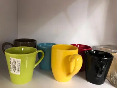 four different colored coffee mugs sitting on a counter at Stylish Pool view studio in Al Dau Heights in Hurghada