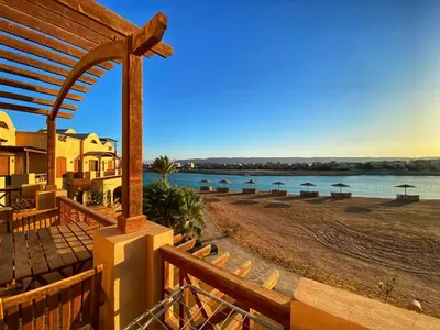 a view of a beach with umbrellas and the water at Sabina El Gouna - Pool and Lagoon Ap-2 in Hurghada