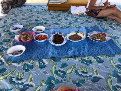 a table with plates of food and bowls of food at Felucca Sailing Boat Overnight Experience in Aswan