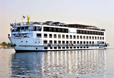 a large cruise ship sitting on the water at Jaz Crown Prince Nile Cruise - Every Monday from Luxor for 07 & 04 Nights - Every Friday From Aswan for 03 Nights in Luxor