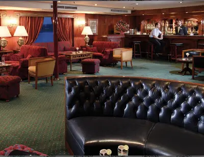 a hotel lobby with a leather couch and a bar at Jaz Crown Prince Nile Cruise - Every Monday from Luxor for 07 & 04 Nights - Every Friday From Aswan for 03 Nights in Luxor