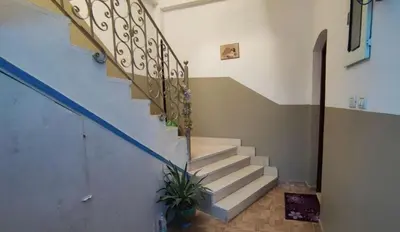 a staircase in a house with a potted plant at Isis - private apartments in Luxor