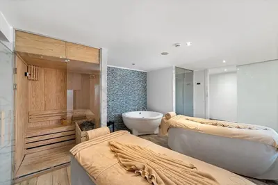 a bathroom with two beds and a bath tub at Steigenberger Aqua Magic, All inclusive in Hurghada