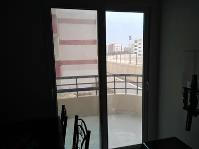 a view of a balcony from a room with sliding glass doors at Studio Apartment at Tiba Star in Hurghada