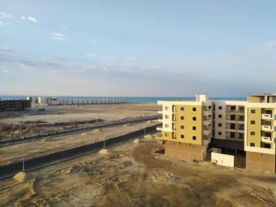 an aerial view of buildings and the beach at Studio Apartment at Tiba Star in Hurghada