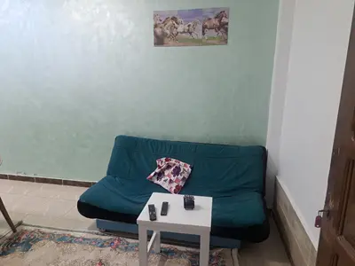 a living room with a blue couch and a table at Sweet Home- ممنوع للمصريين Open 24 Hour in Hurghada